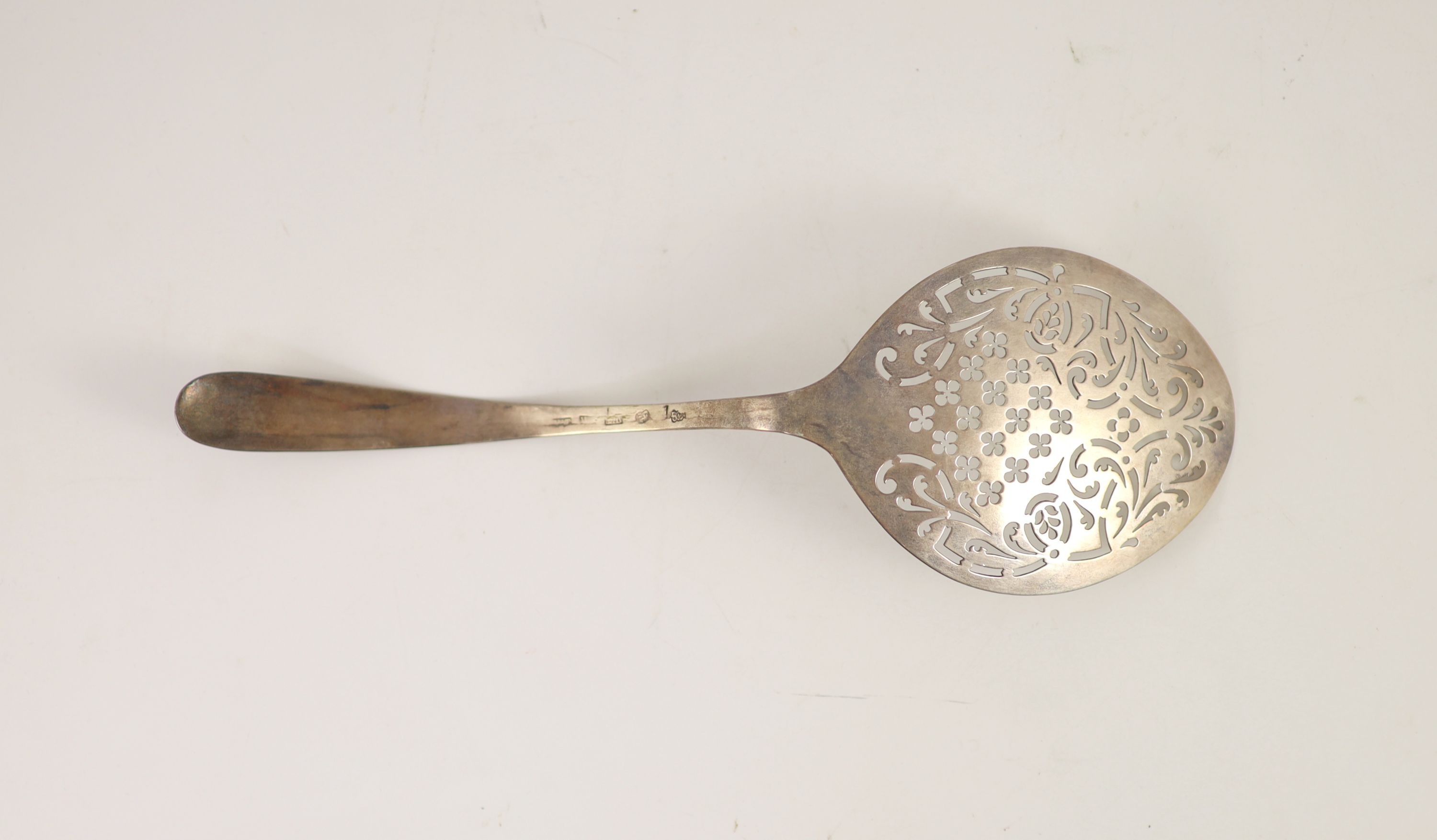 An 18th century Irish pierced silver fish serving ladle, maker W.T., marks rubbed, 30.2cm, 99 grams.